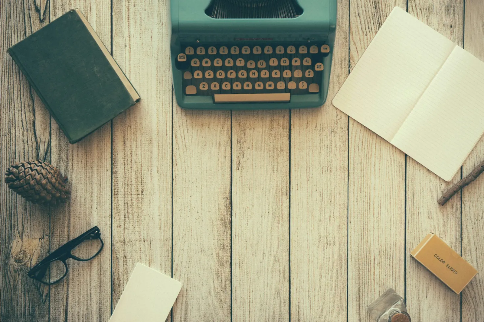 Blog marketing and content writing desk with typewriter and notebooks - ONS Infosolutions